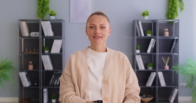 Portrait of professional businesswoman conducts online video call or conference while working in office, enhancing internet communication, dedication in a space focused on business interaction.