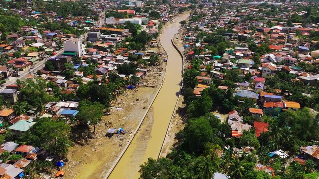 Drone follows muddy Mananga River through Cebu city after typhoon floods