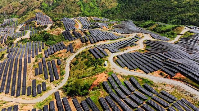 Renewable solar energy infrastructure covering hills in sunny mountain landscape