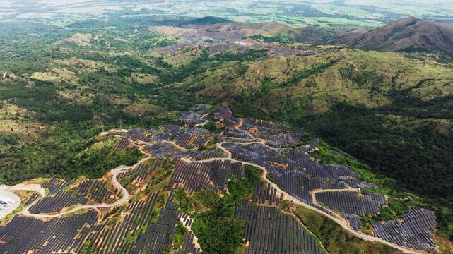 Rows of photovoltaic panels generating renewable energy in mountain valley