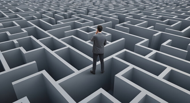 Man standing lost in a complex maze with many paths and walls