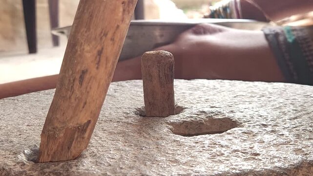 Close-Up of Woman Hand Operating Traditional Stone Grinder Chakki in India, Manual Grain Grinding Process, Rural Kitchen Tool, Authentic Village Lifestyle, Organic Food Preparation 4K Footage