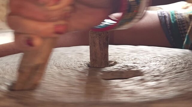 Close-Up of Woman Hand Operating Traditional Stone Grinder Chakki in India, Manual Grain Grinding Process, Rural Kitchen Tool, Authentic Village Lifestyle, Organic Food Preparation 4K Footage