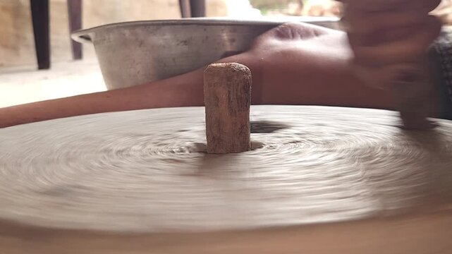 Close-Up of Woman Hand Operating Traditional Stone Grinder Chakki in India, Manual Grain Grinding Process, Rural Kitchen Tool, Authentic Village Lifestyle, Organic Food Preparation 4K Footage