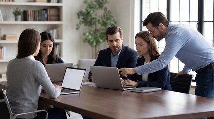 Fototapeta premium Business team collaborating on project with laptops in modern office