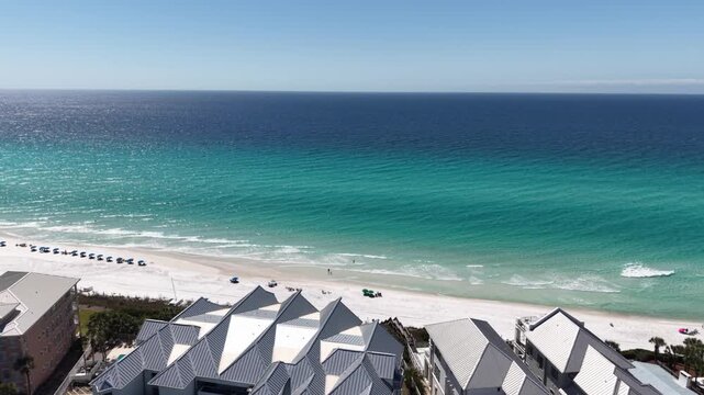 Amazing aerial orbit over the seaside resort buildings facing turquoise Gulf at Alys Beach, Panama City, Florida, USA