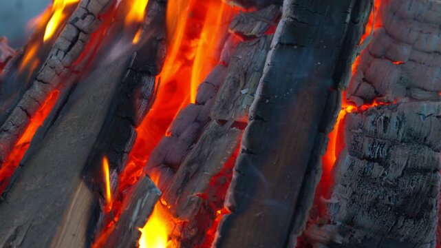 Burning and smoldering coals of a campfire close-up. The process of gorenje wood in the fresh air.