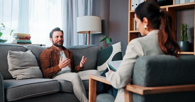Happy man, patient and talking with therapist for counseling, rehabilitation or therapy session. Male person, client and speaking with counselor or psychologist for mental health or advice in office