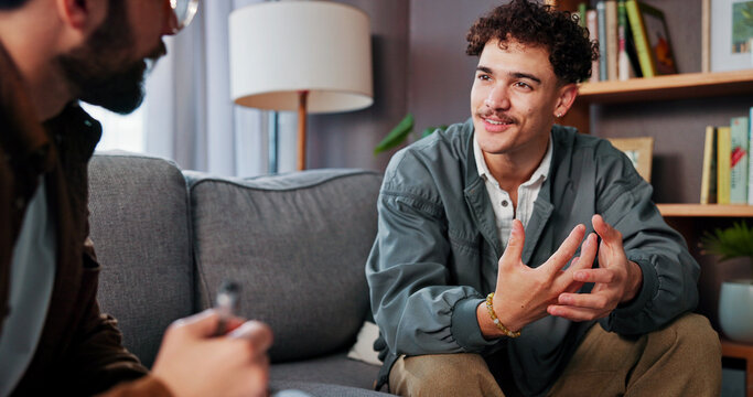 Psychology, therapist and happy man talking for help, mental health advice or support in office. Counseling session, life coach and people in therapy for assessment, consultation and evaluation