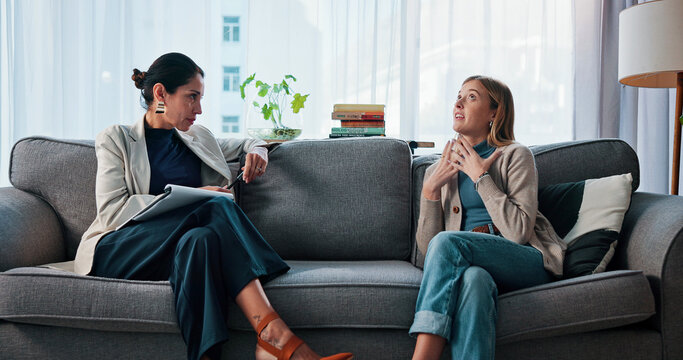 Psychologist, woman and talking in therapy on sofa for divorce grief, share story and life transition. Listening, patient and doctor with notes in CBT counseling for mental health, healing or support