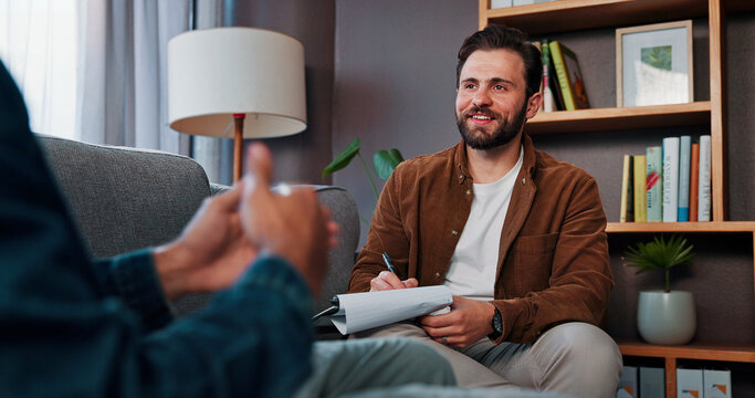 Psychology, therapist or man listen with clipboard for help, mental health advice or hands in office. Writing notes, psychiatrist and client in counseling session for consultation, smile or therapy