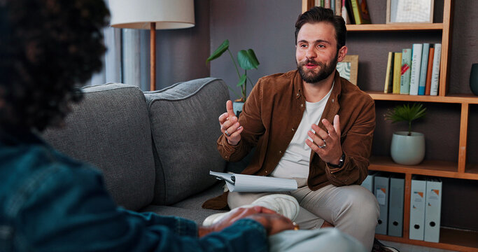 Counseling, therapist and man talking to client for help, mental health advice or support in office. Therapy, life coach and patient in psychology session for assessment, consultation and evaluation