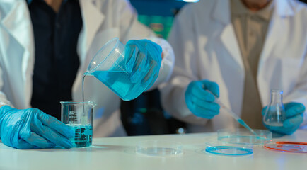 Fototapeta premium Science and medicine, scientist analyzing and dropping a sample into a glassware, experiments containing chemical liquid in laboratory on glassware, innovative and technology.