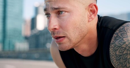 Fototapeta premium Runner, tired and man in city breathe from exercise, workout and training with fatigue. Sports, athlete and person in town for rest, challenge and fitness for active hobby, wellness and health