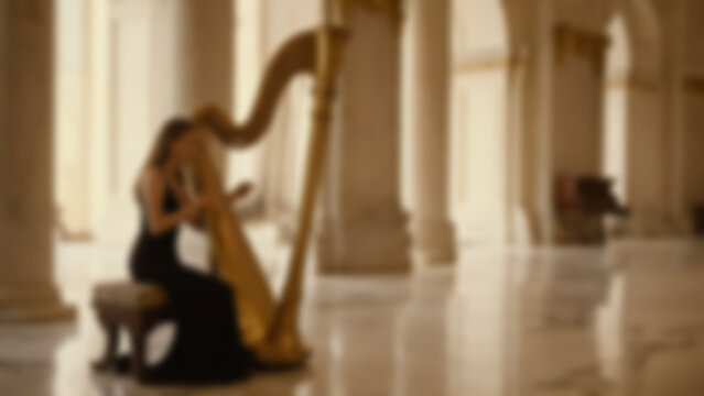 Blurred background of harpist in an elegant palace hall with marble floors and golden pillars, detailed harp strings and reflections, evening, warm golden lighting.