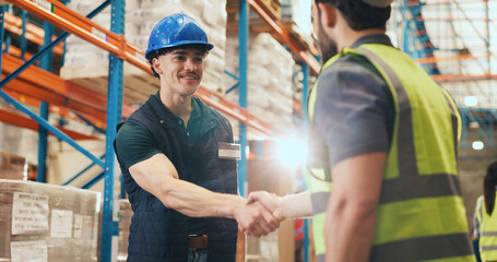 Happy, business people or logistics with handshake in warehouse for partnership together. Businessmen, colleagues or employees shaking hands with flare for shipping success, deal or teamwork in depot