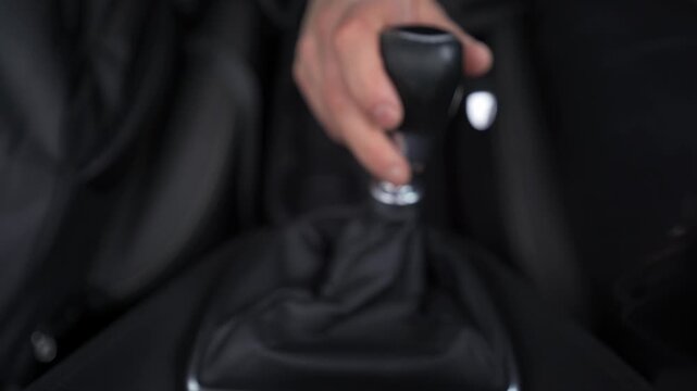 Hand shifting gears in manual transmission car