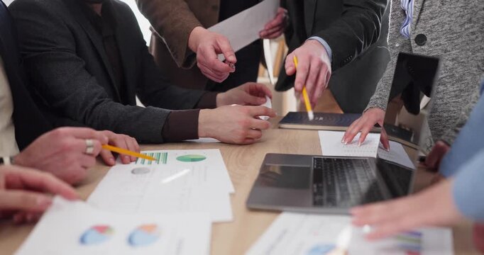 Teamwork team people hands meeting business analysis. Colleagues review charts by laptop in office discuss data align goals and budget coordinate tasks for planning projects. We act as one team.