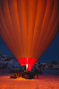 Flame inflating hot air balloon before sunrise flight in Cappadocia