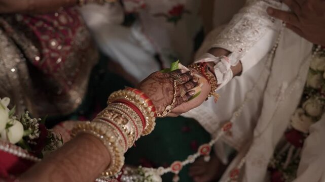 Indian Bride and Groom holding hand ritual, Hindu Hasta melap in Hindu Wedding, Bride and Groom Holding Hands Ritual. Indian Wedding Closeup	
