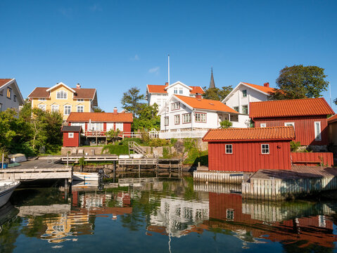 Waterfront houses and boathouses in Gullholmen harbour on H&auml;rman&ouml; island, Bohusl&auml;n archipelago, west coast Sweden