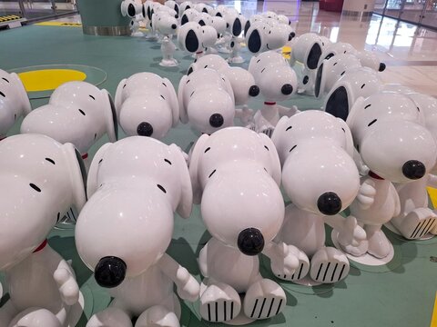 Crowd of Snoopy Peanuts Character Figures Displayed in Row at Public Mall Exhibition for Promotional Marketing Event and Iconic Cartoon Fan Collection Decor on April 15, 2025 in Bangkok, Thailand
