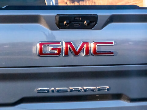 Calgary, Alberta, Canada. March 20, 2026. Close-up of the Chrome GMC and Sierra Logo Emblems on the Tailgate of a Silver Pickup Truck.