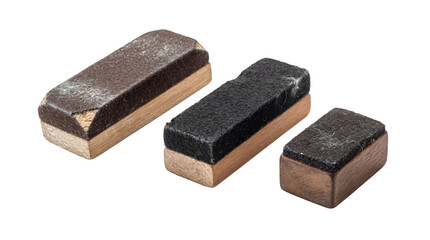Photograph of three rustic, well-used chalkboard erasers with wooden blocks and dark felt surfaces. © Isla