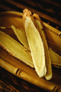 Sliced astragalus root on wooden tray