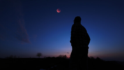 Fototapeta premium Amateur astronomer observing stars, planets, Moon eclipse and other celestial objects.
