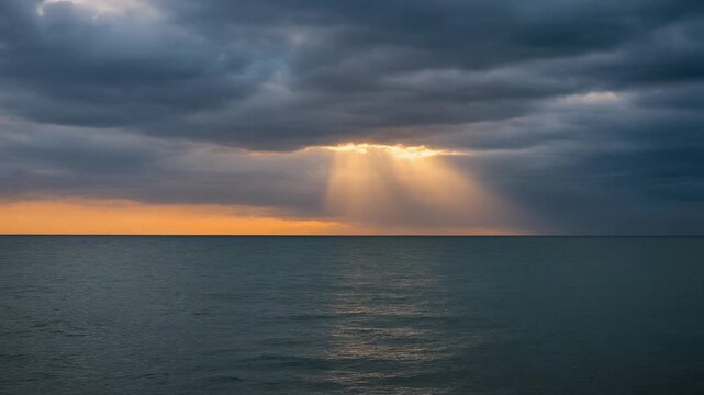 dramatic ocean sunset with sun rays through clouds