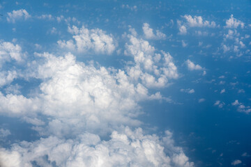 Fototapeta premium Blue Sky with White Clouds, Flying above Sunny Cloudy Sky Texture Pattern Plane View