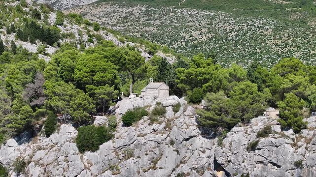 Aerial drone shot of St Juraj Gradac with wide view over Omis and Adriatic coast.