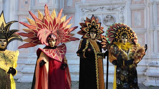 Venice, Italy - February, 2026 - People dressed in masks for the Venice Carnival have their photos taken by tourists	
