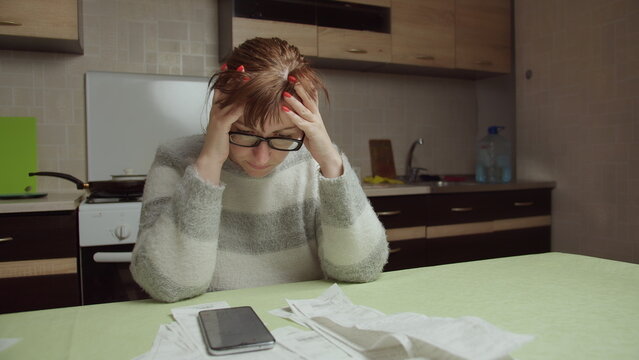 Stressed Woman Calculating Expenses at Home Kitchen Table, have fun and enjoy