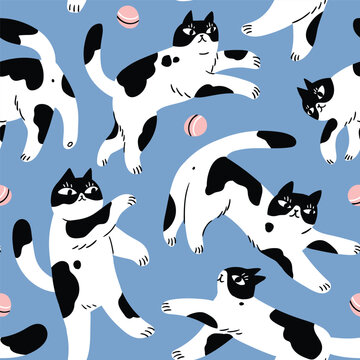 Vector cat seamless pattern. Cute animals fabric or wrapping paper seamless design. Whimsical bleck and white cats and balls on blue background. 