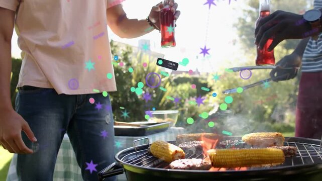Animated AR overlays appearing, two men clinking bottles and flipping burgers, celebrating cookout