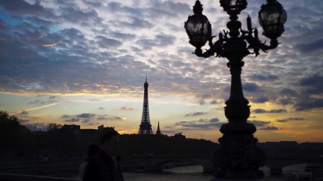 Paris Eiffel Tower in France behind street lantern on bridge