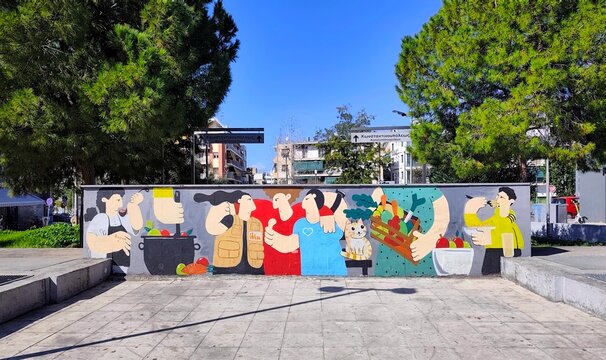 Photo of a colorful street art mural at Kerameikos Square, near the metro station entrance in the Gazi district. Kerameikos Square is a popular area in Athens, Greece.