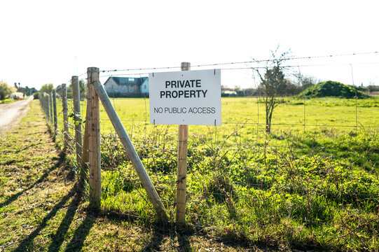 Generic Private Property sign attached to a newly erected fence at the perimeter of a private horse paddock in the UK. The fence extends to a few acres to help prevent illegal access and fly tipping.