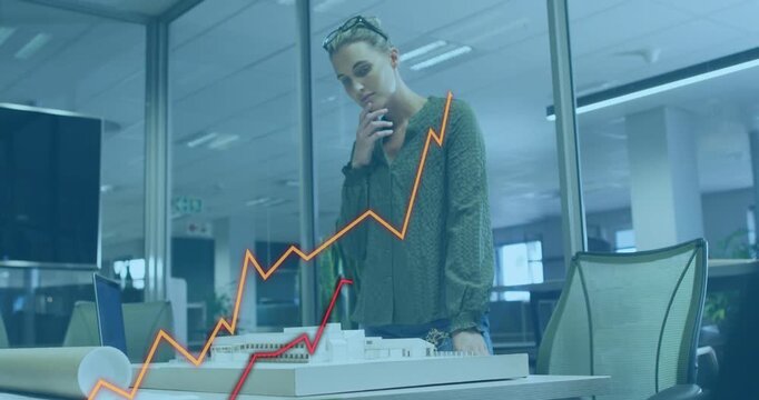 Architect leaning over scale model in office, animated graphs appearing, assessing project impact