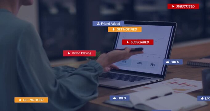 Lifting smartphone, woman in teal top using laptop, dictating chart notes amid badges, copy space
