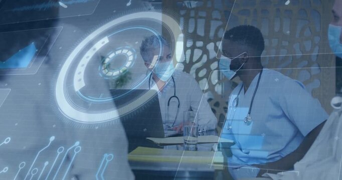 Lead MD tapping laptop starting case review while clinic team reviewing notes with holo overlaying