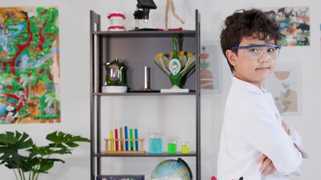 Young Asian Boy in Lab Coat and Goggles Standing Proudly