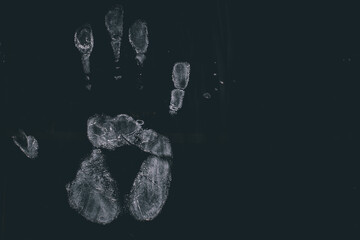 Naklejka premium White human handprint and palm print texture detail on a jet black background with grunge effect