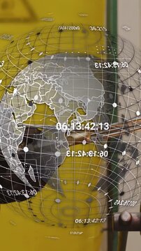 Vertical video: Glassmaker using torch, rotating rod, shaping glass into ball with globe turning