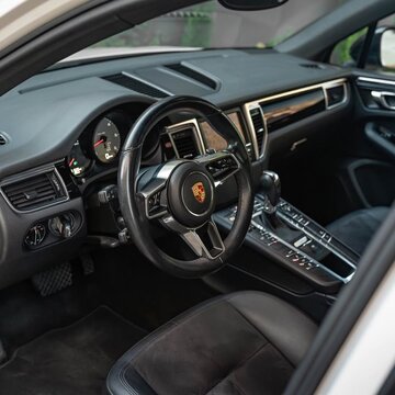 Porsche Macan car interior showing steering wheel and dashboard