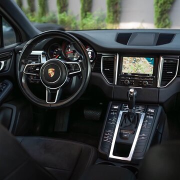 Porsche Macan SUV interior with dashboard and steering wheel