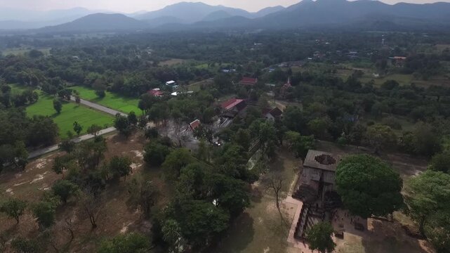 Aerial view of Wat Si Chum temple with the iconic giant seated Buddha statue in Sukhothai Historical Park, Thailand.