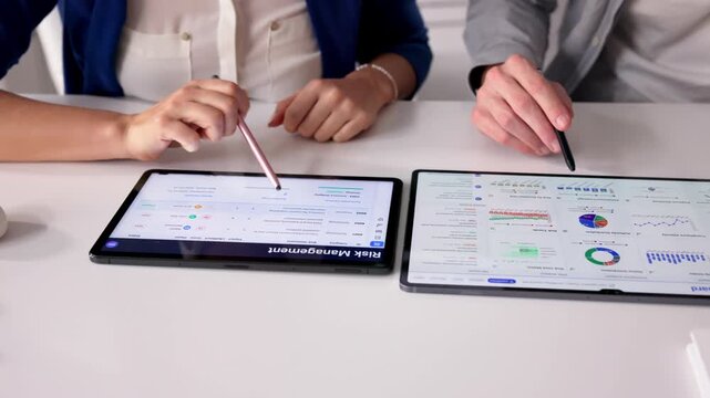 Compliance Manager Reviews Risk Dashboard On Tablet